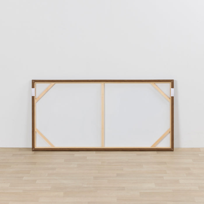 Wooden picture frame with glass on a white wall