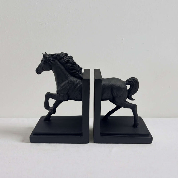 A pair of black horse bookends featuring sculpted galloping horse figures mounted on rectangular bases, photographed against a plain light background.