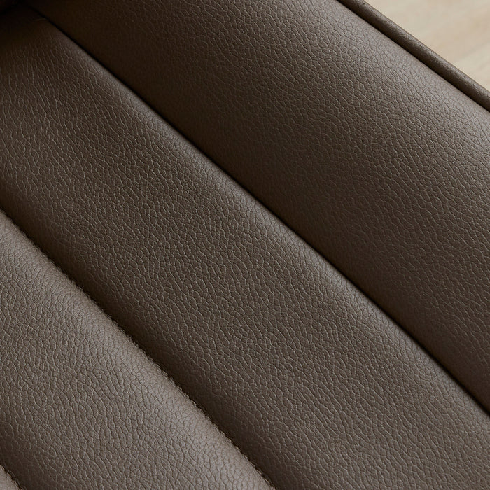 Close-up of a textured leather or faux-leather surface in a warm taupe-brown color, showing stitched diagonal channels.