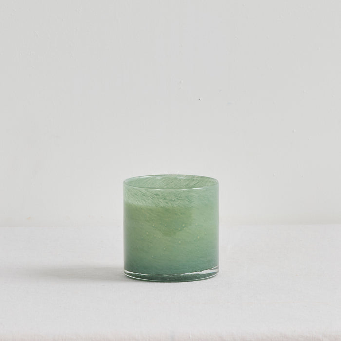 Aurora Candle - Mandarin Spice, luxury home fragrance in a soft green glass vessel with a warm zesty scent.