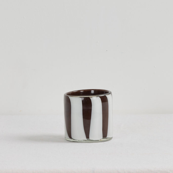 Aurora Candle - Tobacco Leaf & Saffron home fragrance candle in a brown and white organic striped glass vessel