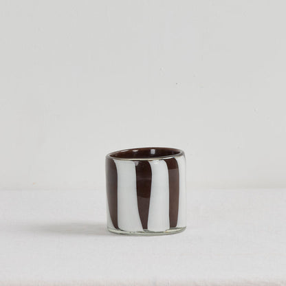 Aurora Candle - Tobacco Leaf & Saffron home fragrance candle in a brown and white organic striped glass vessel