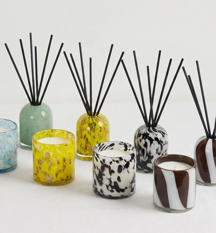 Aurora Candle - Tropical Crush in a mottled yellow glass vessel, styled with matching home fragrance diffusers and candles