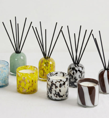 Aurora Candle - Tropical Crush in a mottled yellow glass vessel, styled with matching home fragrance diffusers and candles