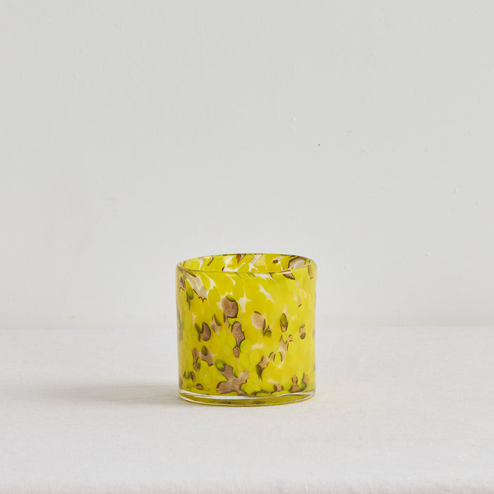 Aurora Candle - Tropical Crush home fragrance candle in a mottled yellow glass vessel on a white surface
