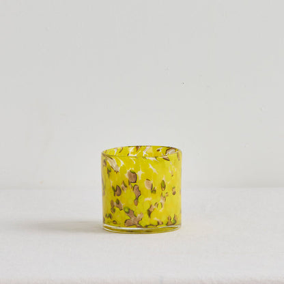 Aurora Candle - Tropical Crush home fragrance candle in a mottled yellow glass vessel on a white surface