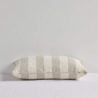 Benton 30x50cm Cushion - Natural Stripe, textured neutral striped cushion with visible zip closure on a white bed.