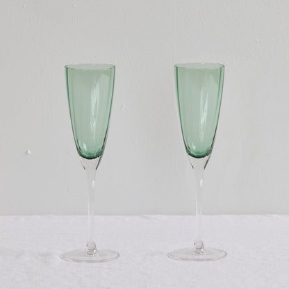 Bravo Champagne Glass Set - 2pc - Green, two sleek soft green glass champagne flutes with clear slender stems.