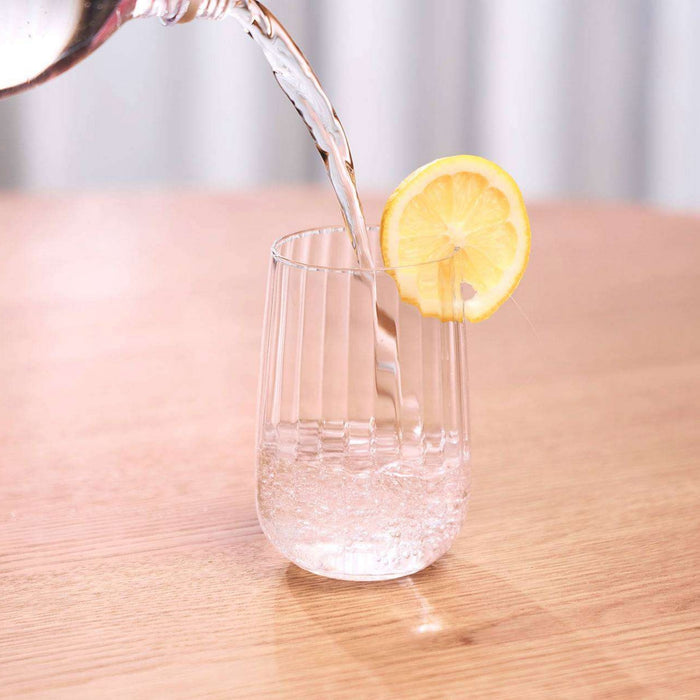 Bravo Tall Tumbler Set - 2pc - Clear, clear ribbed glass tumbler being filled with water and garnished with lemon.