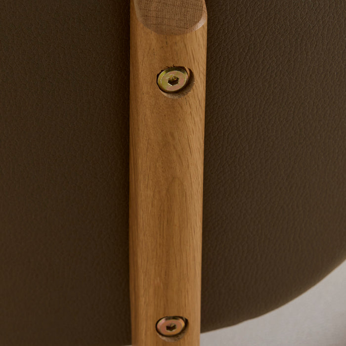 Briar Dining Chair - Oak/Olive close-up of warm oak-toned frame, visible brass fixings and olive upholstery texture