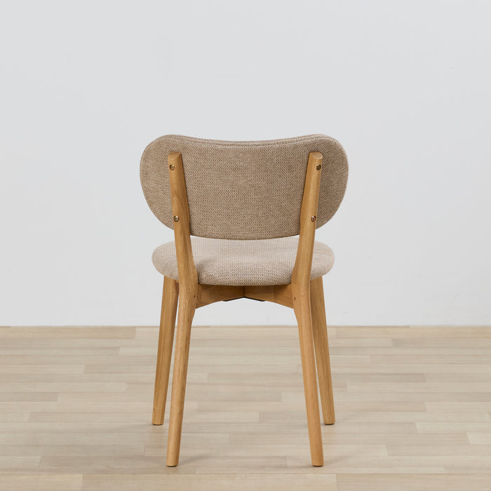 Chair with wooden frame and beige cushioned seat and backrest on a light wooden floor.