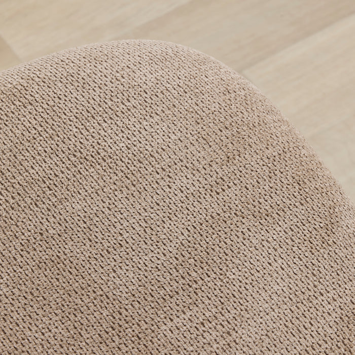 Close-up of a textured beige cushion on a wooden floor