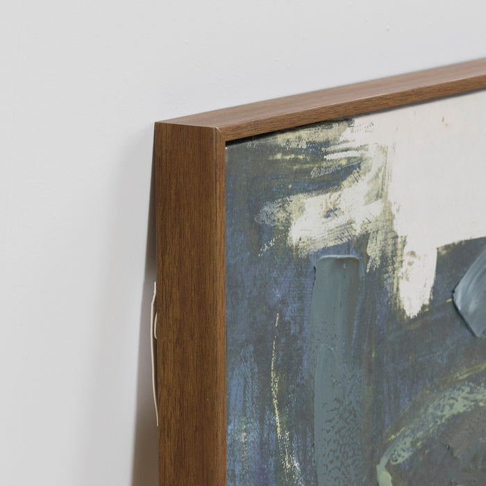 Close-up of a wooden picture frame with an abstract painting inside.