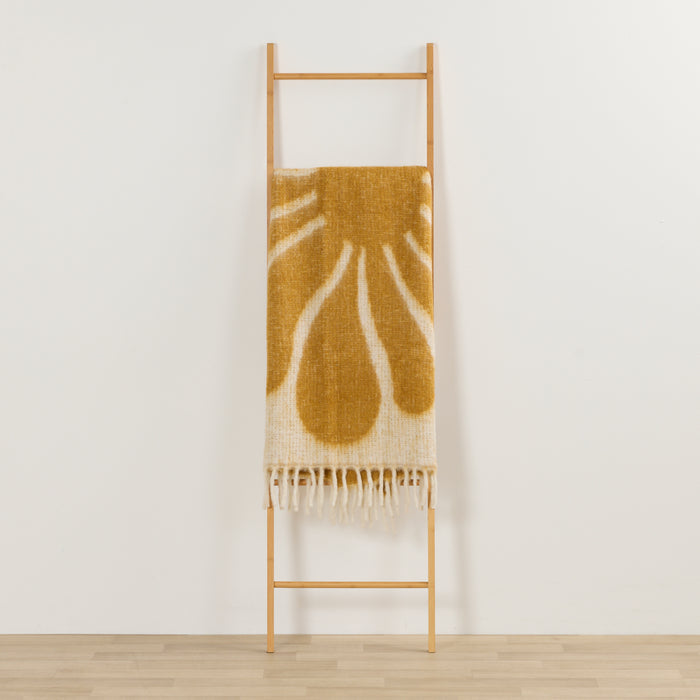 Happy Throw - Gold/White thick cosy throw with organic gold pattern and fringe, draped over a timber ladder.