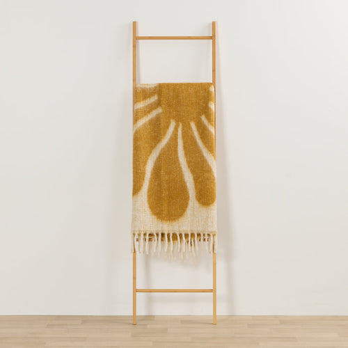 Happy Throw - Gold/White thick cosy throw with organic gold pattern and fringe, draped over a timber ladder.
