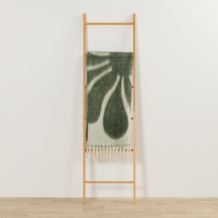 Happy Throw - Green/White thick cosy throw with playful organic pattern and fringe, draped over a timber ladder.