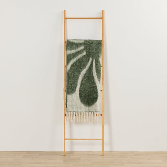 Happy Throw - Green/White thick cosy throw with playful organic pattern and fringe, draped over a timber ladder.