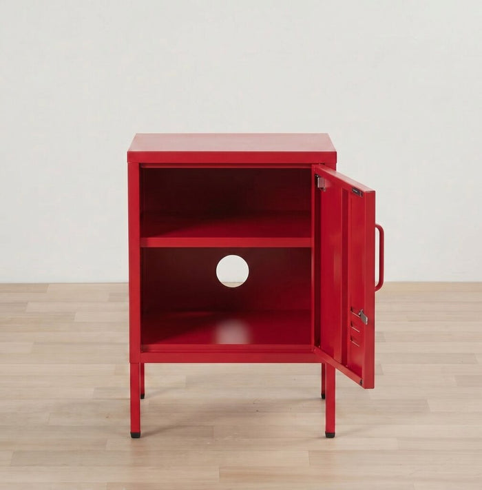 Red metal cabinet with open door on a wooden floor.