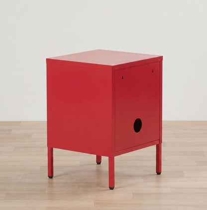 Red nightstand on a wooden floor with a white wall background