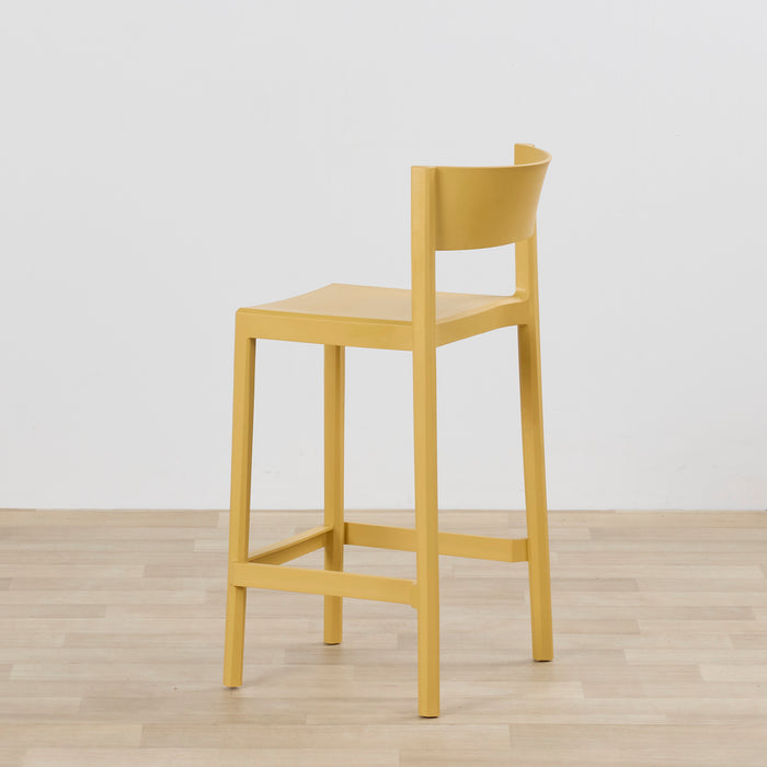 Kip Counter Stool - Yellow with mustard finish, square seat, curved open backrest and footrest on timber flooring