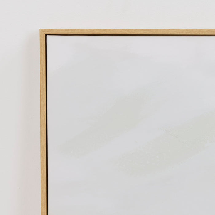 Oak picture frame on a white wall