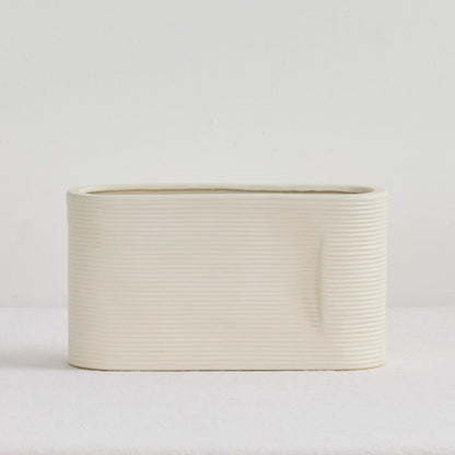 Linea Low Vase - Bone, low wide ribbed ceramic vase with a softly rounded rectangular silhouette and neutral finish
