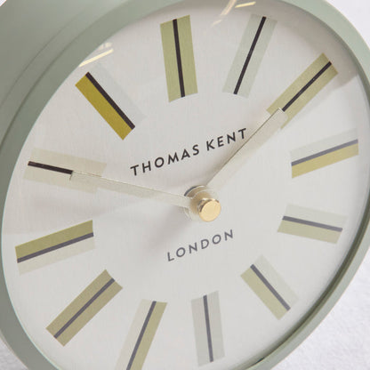 Close-up of a Thomas Kent London wall clock showing a white dial with minimalist beige, gray, and black linear hour markers and a gold center hub.