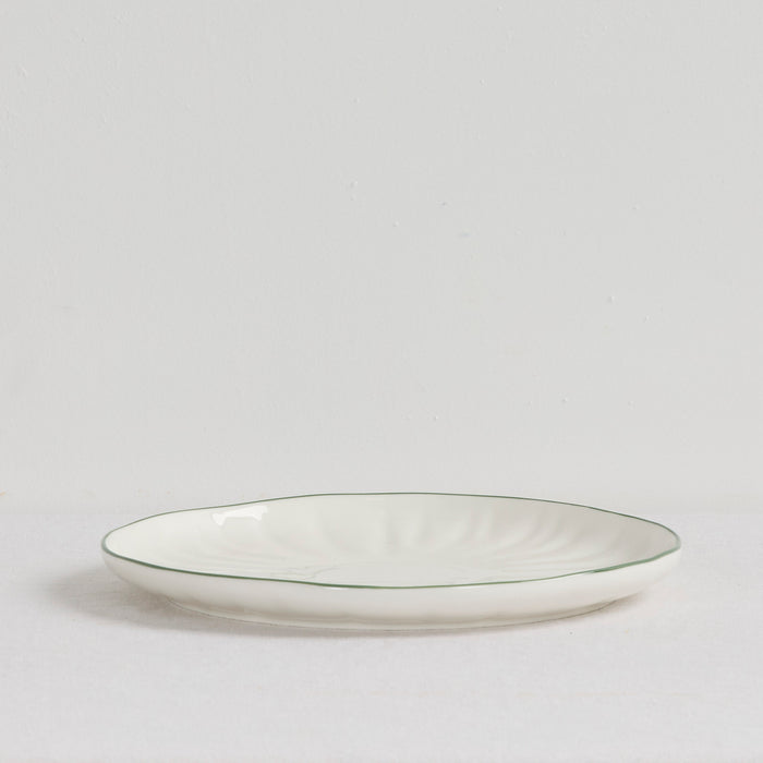 Lotus Dinner Plate - White/Green, white dinnerware plate with subtle fluting and a slim green rim on a white surface