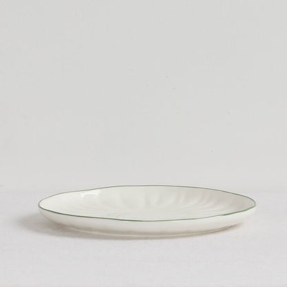 Lotus Dinner Plate - White/Green, white dinnerware plate with subtle fluting and a slim green rim on a white surface