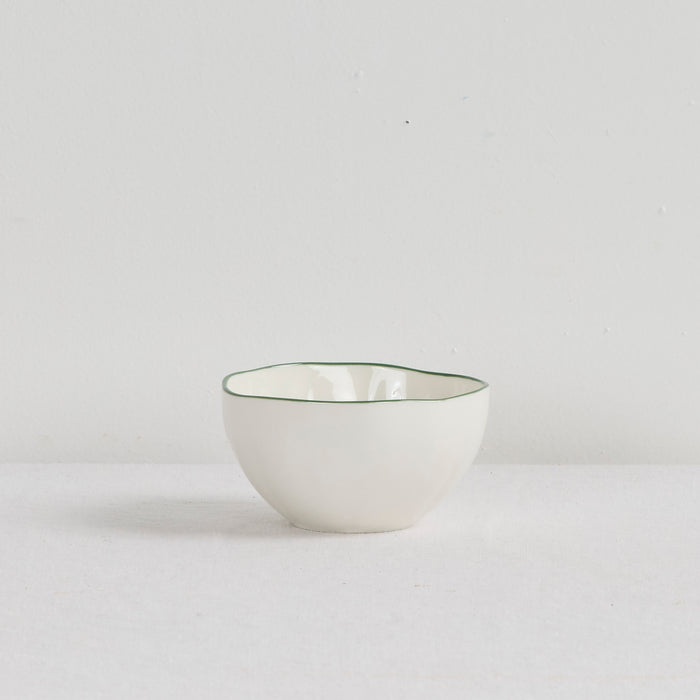 Lotus Snack Bowl - White/Green, small white dinnerware bowl with a fine green rim on a neutral surface
