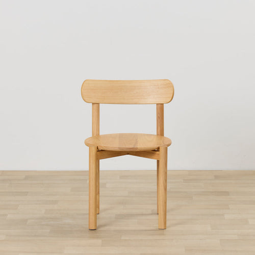 Maeve Dining Chair - Natural, solid wood dining chair with rounded seat and curved backrest on timber flooring