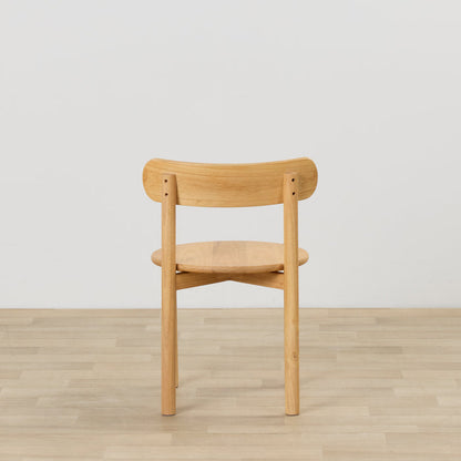 Maeve Dining Chair - Natural, rear view of solid wood dining chair with curved backrest on light timber flooring