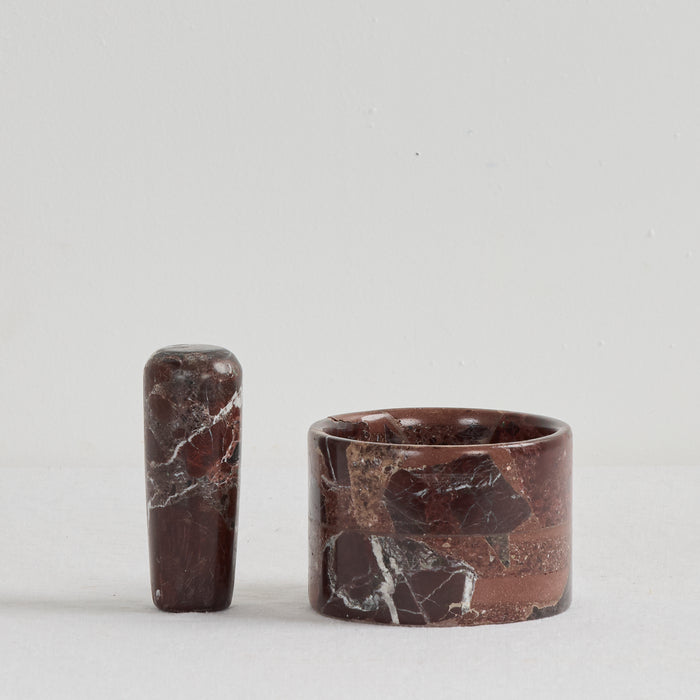Two brown marble objects on a light gray background