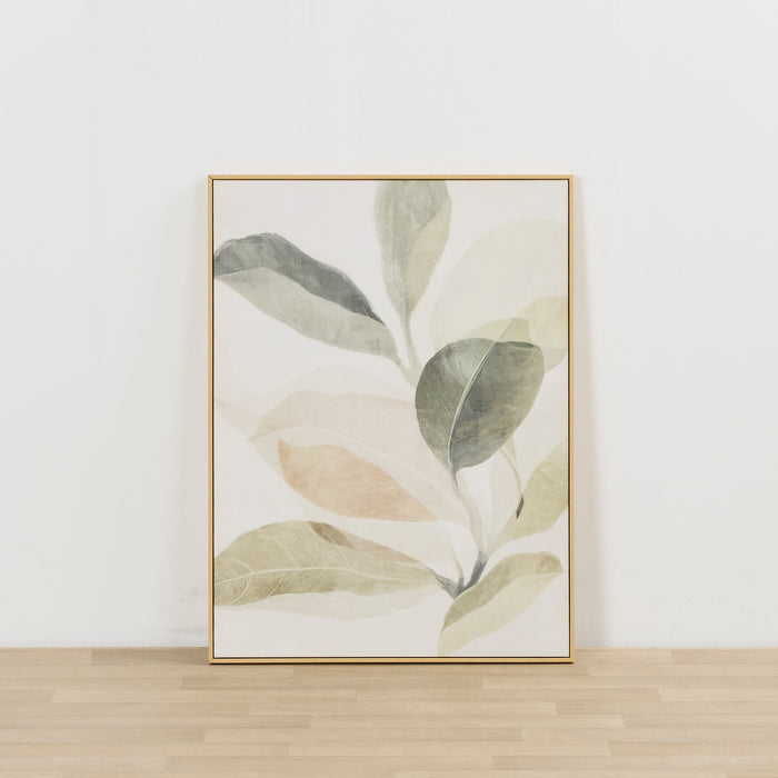 A framed botanical art print featuring watercolor-style leaves in muted green, beige, and gray tones, displayed against a white wall on a light wood floor.