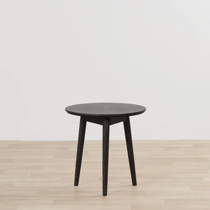 Orlando Small Side Table - Black round black side table with tapered legs on a light timber floor