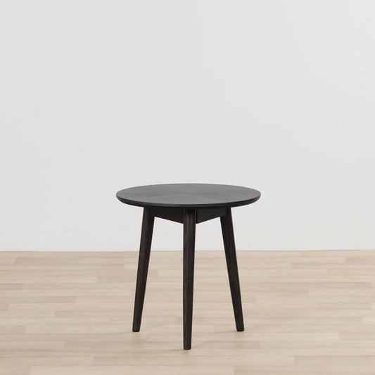Orlando Small Side Table - Black round black side table with tapered legs on a light timber floor