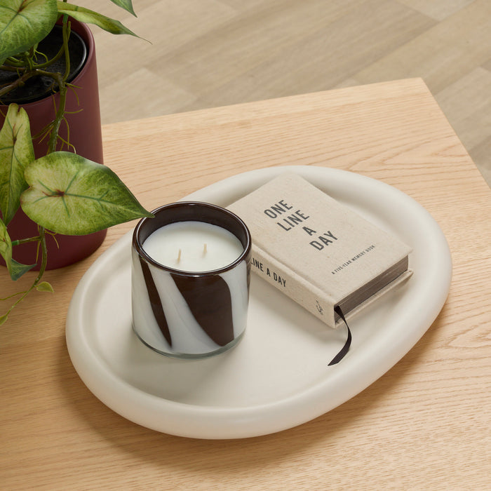 Pebble Large Tray - Bone oval tray styled with a candle and book on a light timber table.