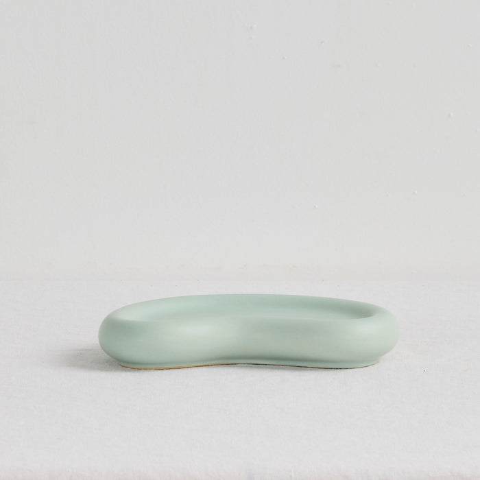 Pebble Small Tray - Sage, low organic-shaped sage green tray with a smooth matte finish and raised rim