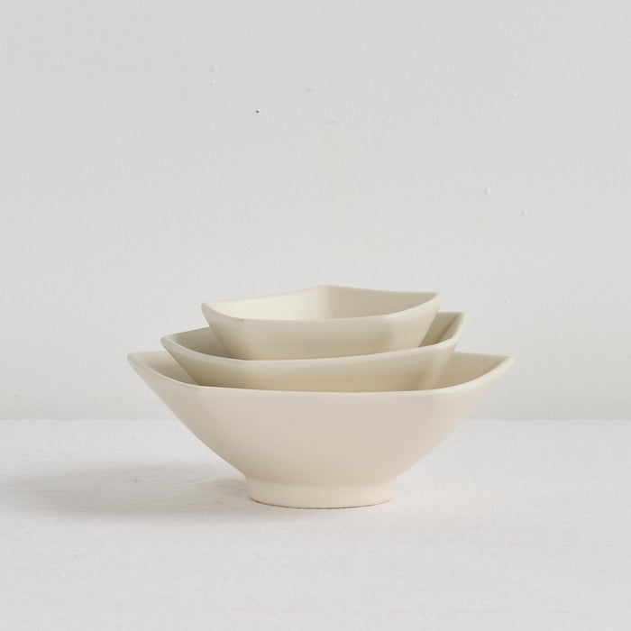 Pentagon Medium Bowl - Bone, smooth bone dinnerware bowl nested with matching angular bowls on a neutral surface