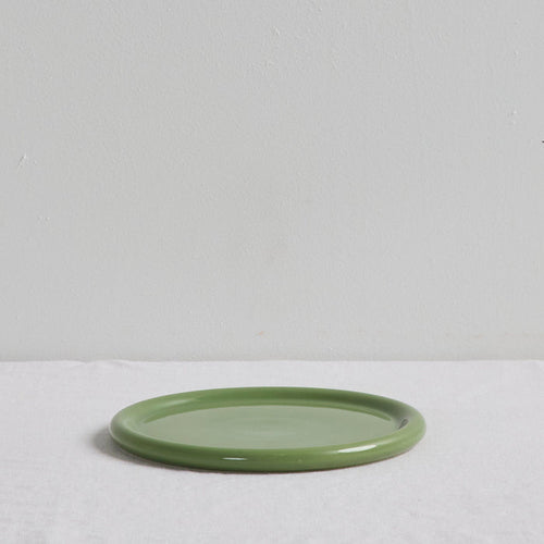 Green ceramic plate on a light gray background