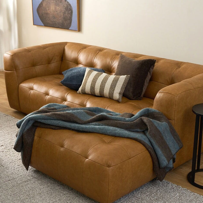 Rooney Throw - Choco/Lake, soft wool striped throw draped over a caramel leather sofa in a contemporary living room.