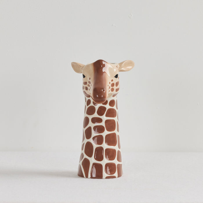 Giraffe-shaped ceramic vase on a light gray background