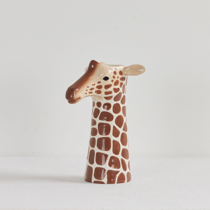 Giraffe-shaped ceramic vase on a light gray background