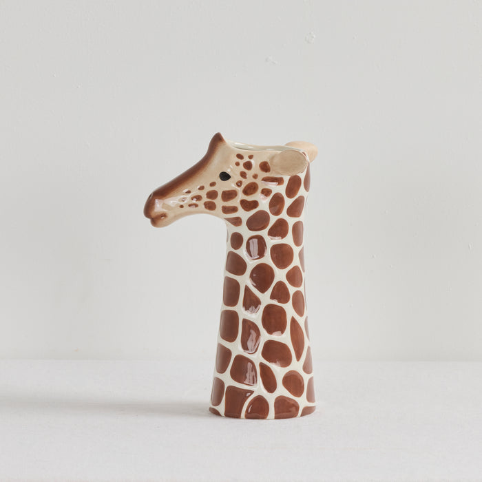 Ceramic vase shaped like a giraffe's head on a light gray background