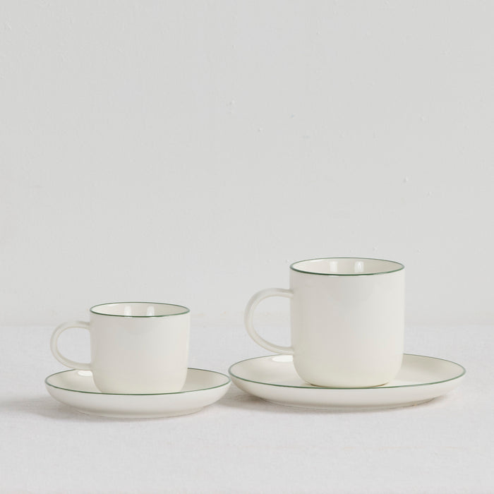 Soma Coffee Cup & Saucer - White/Green dinnerware set with two white cups and matching green-rimmed saucers.