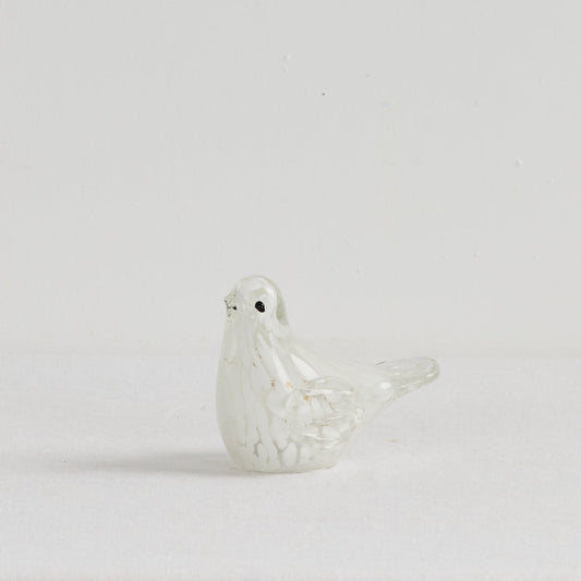 White ceramic dove on a light gray background