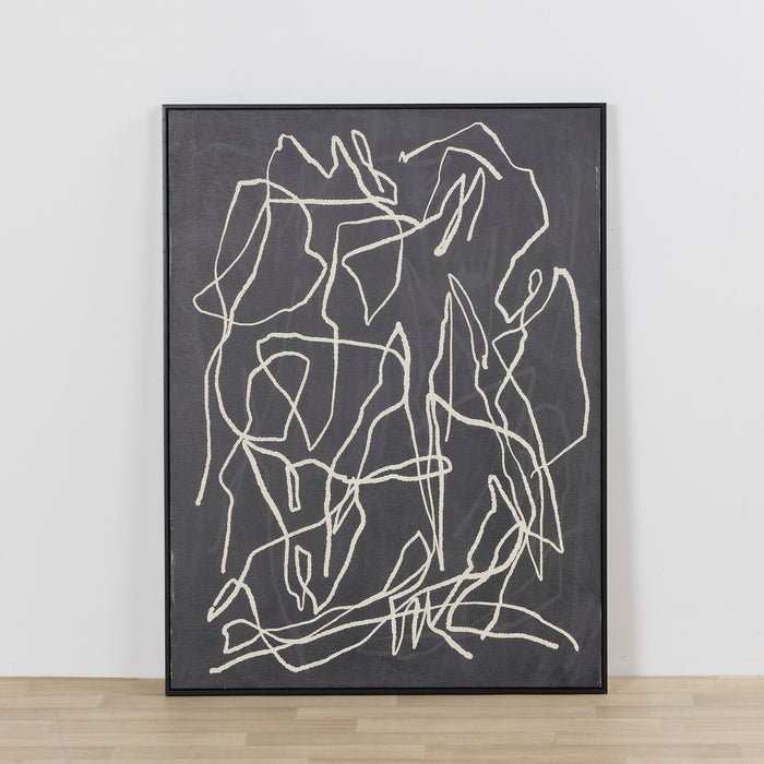 Close-up of dark gray artwork with a diagonal seam