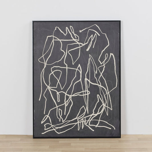 Close-up of dark gray artwork with a diagonal seam