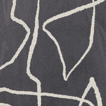 Close-up of a textured surface with white abstract line patterns on a dark background