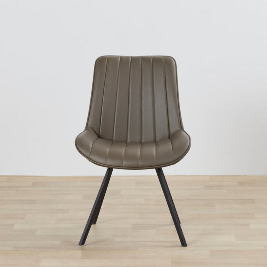 Brown chair with black legs on a wooden floor and light gray background